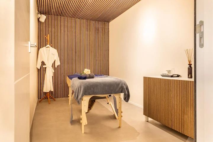 Treatment room with a massage table and plants